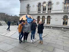 Students posing in front of globe sculpture in Trinity College